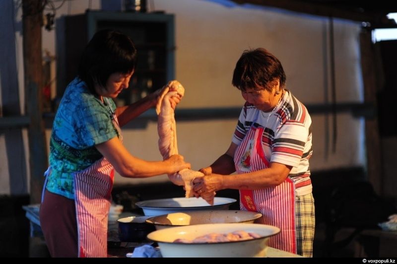 Казахская семья в осенний сезон готовит согым — традиционную заготовку мяса на зиму и казы, национальный деликатес, символизирующий уважение к труду и преемственность традиций. Согым, казы, традиции Казахстана, конина, сельская жизнь, казахская кухня, Алматинская область, Карлыгаш Нуржан, Shanger.kz