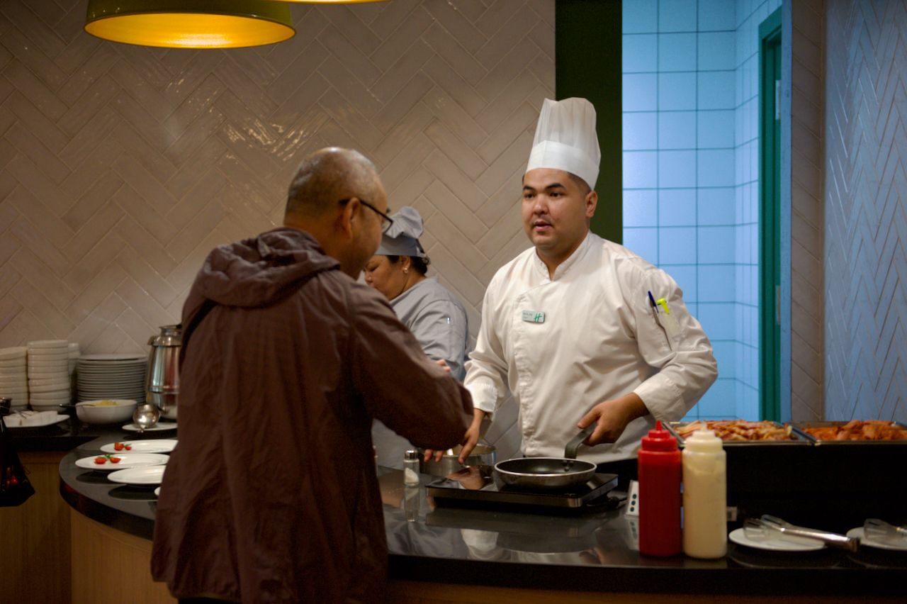 Команда Holiday Inn приветствует гостя в уютном лобби отеля: улыбка, чек-ин и профессионализм, Holiday Inn, гостеприимство, отель, сервис, путешествия Казахстан, лобби отеля, идеальный приём